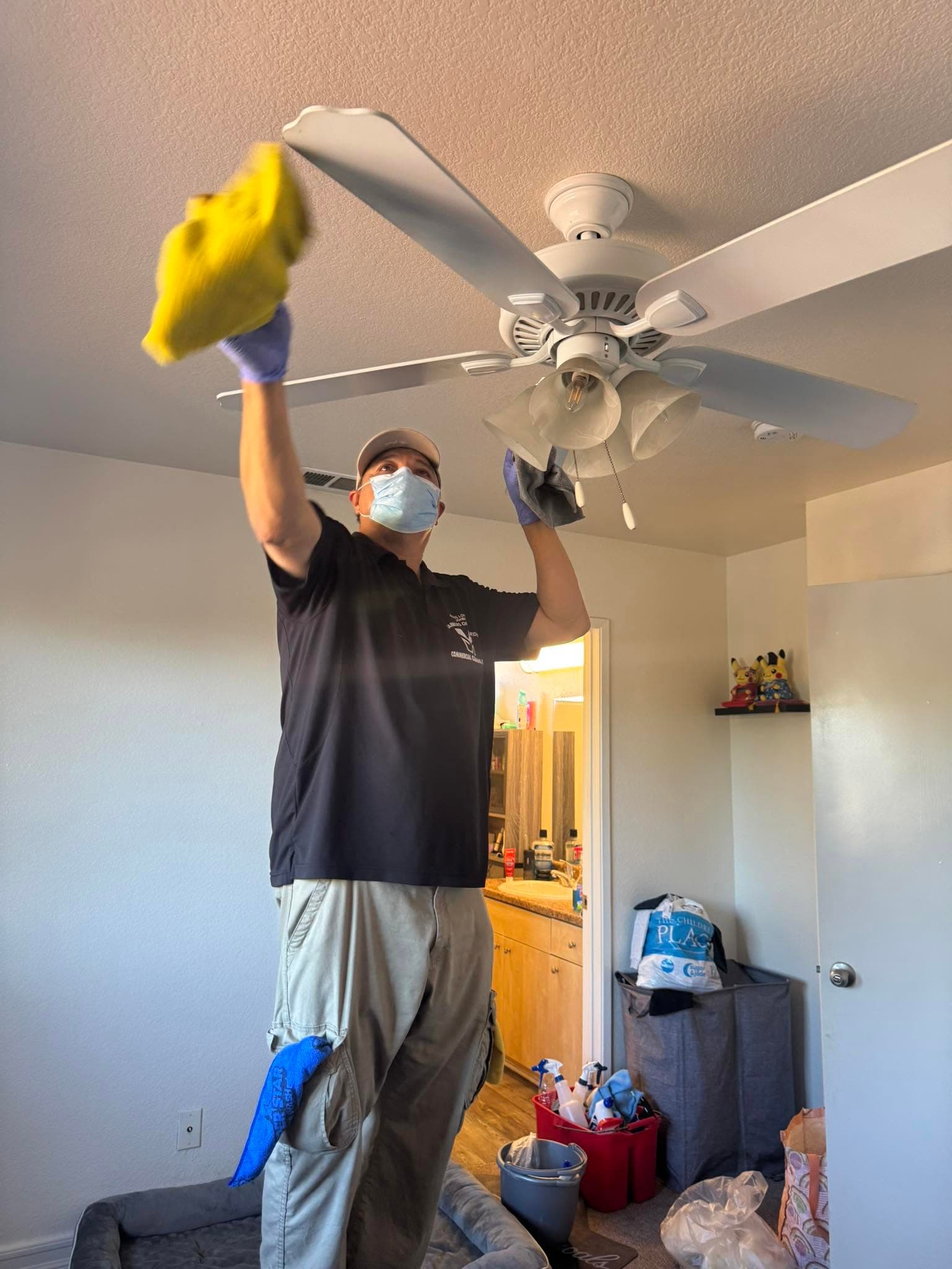 Warriors of the Order cleaner detailing ceiling fan blades in a North County home