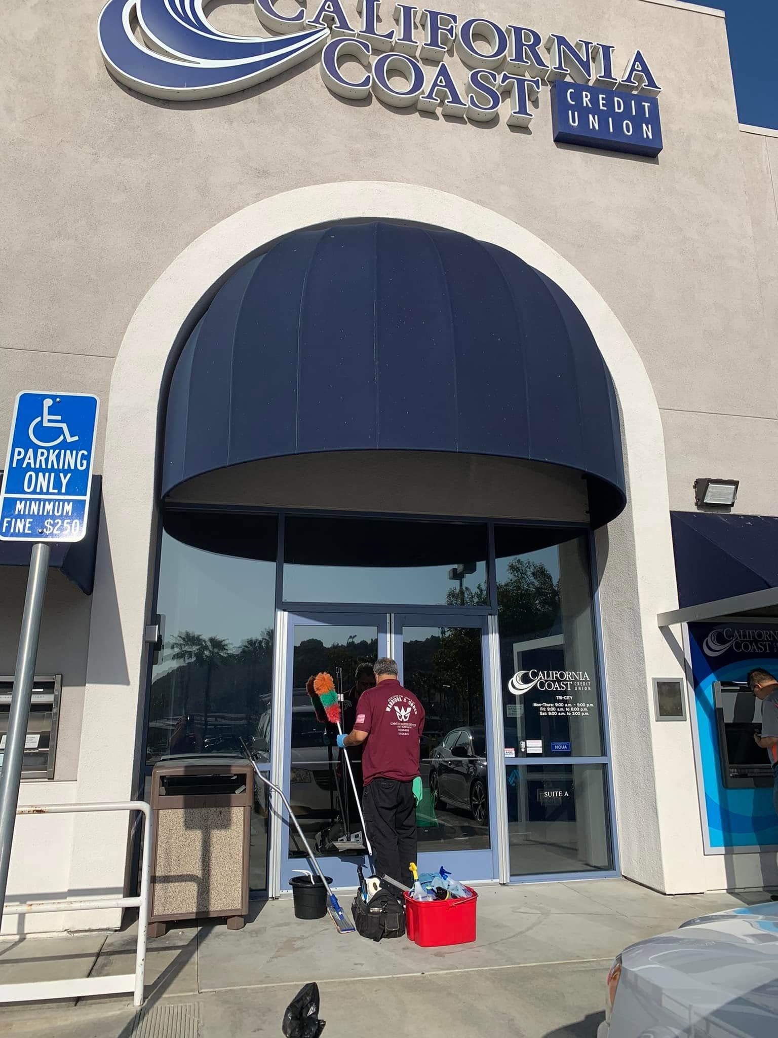 A commercial storefront entrance cleaned by the Warriors of the Order crew