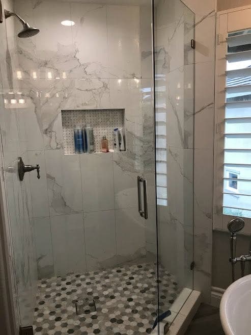 A marble walk-in shower cleaned to a shine by Warriors of the Order