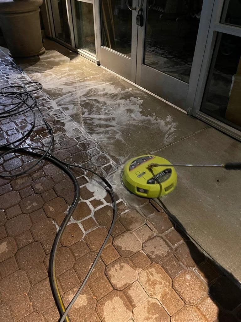 A driveway being pressure washed by Warriors of the Order in North San Diego County
